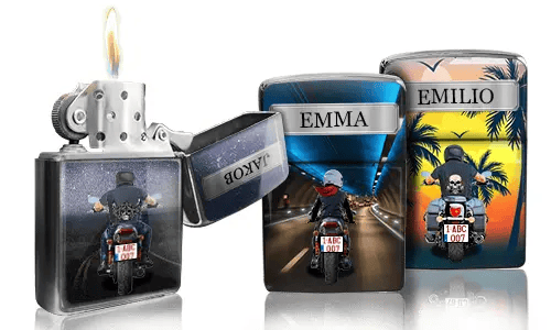 Three Zippo lighters with custom designs: one lit with a night highway scene, another showing a rider with 