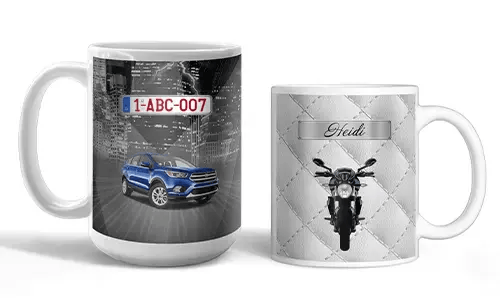Two white mugs with vehicle-themed prints: blue SUV with city lights, motorcycle with quilted silver background and name Heidi