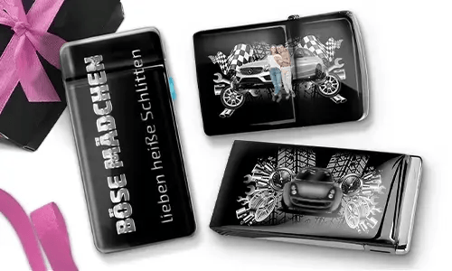 Three shiny black objects with car-themed designs. One reads 