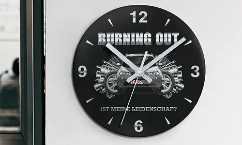 Wall clock with motorcycle and engine graphics, BURNING OUT IST MEINE LEIDENSCHAFT text on black face
