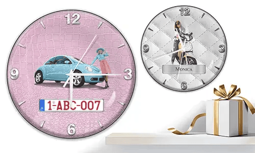 Two wall clocks with female figures and vehicles: left with black car on purple waves, right with red and black cars, racing flags, and blue background